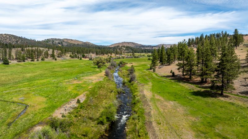 River running through green mountain valley.